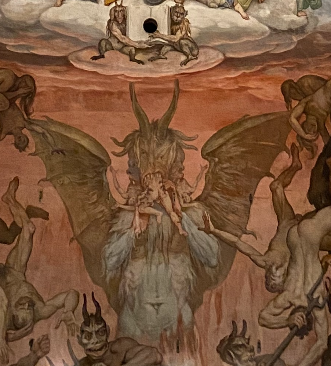 Devil eating human 'alive' is a common theme of the visualisation of Last Judgement of the Christ. We will see similar visualisation in Michelangelo's interoperation of the theme in the ceilings of the Sistine Chapel in Rome.